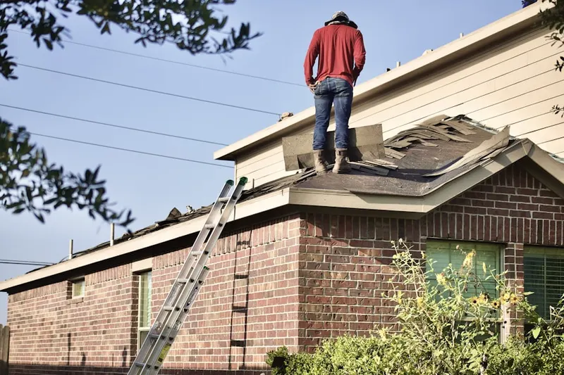 Professional roofer working on a residential roof in Mission Estates